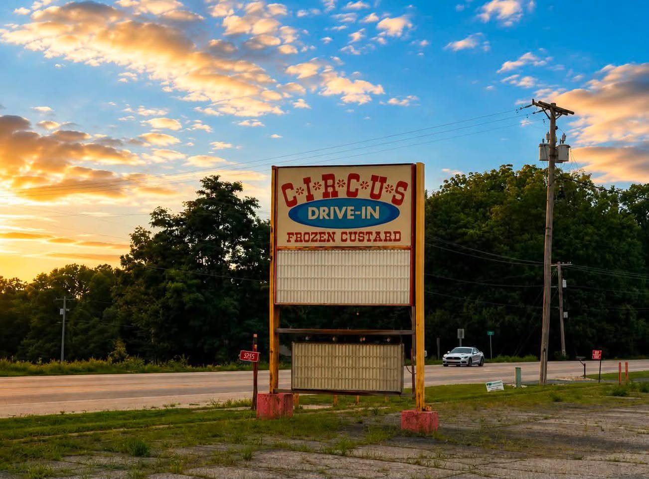 The large Circus Drive-In and frozen custard sign beside Highway 51 at sunset