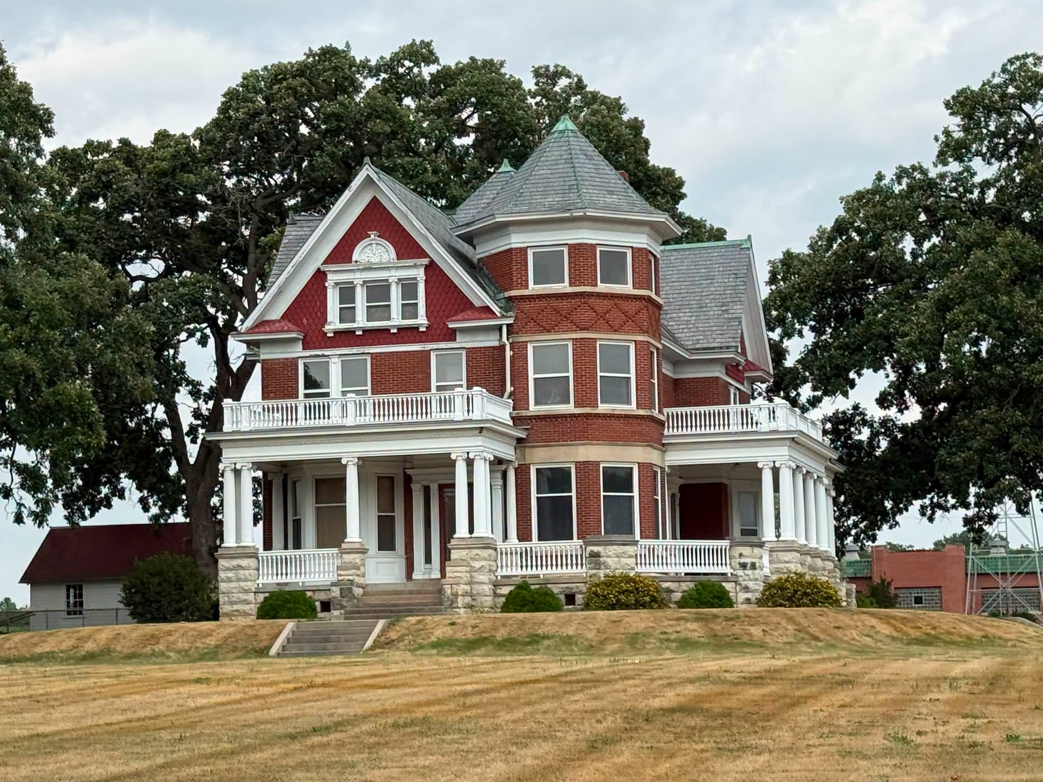 Closer view of the Queen Anne details, turret and porches of the former Klondike Farmhouse